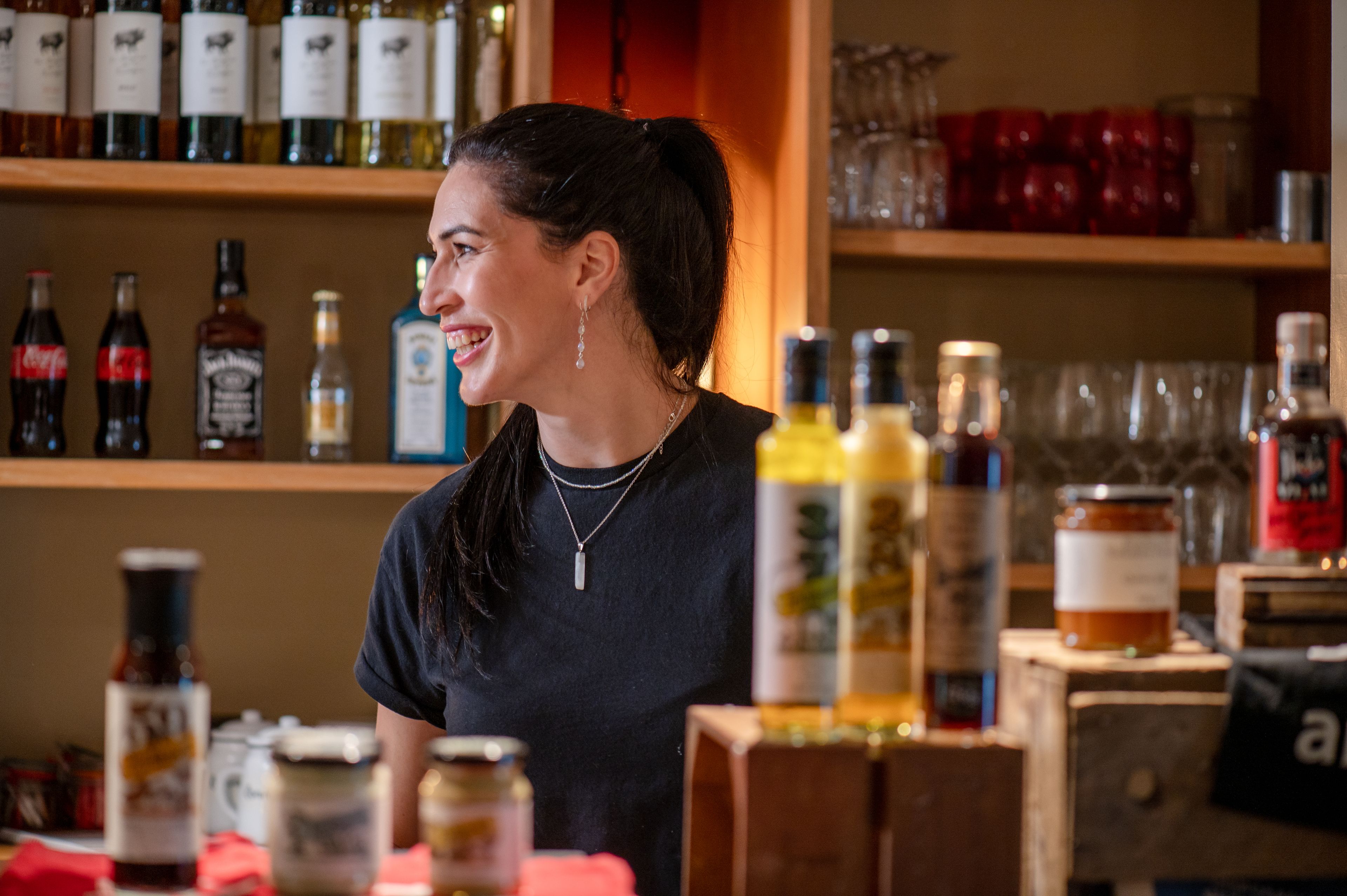 Staff member smiling behind counter