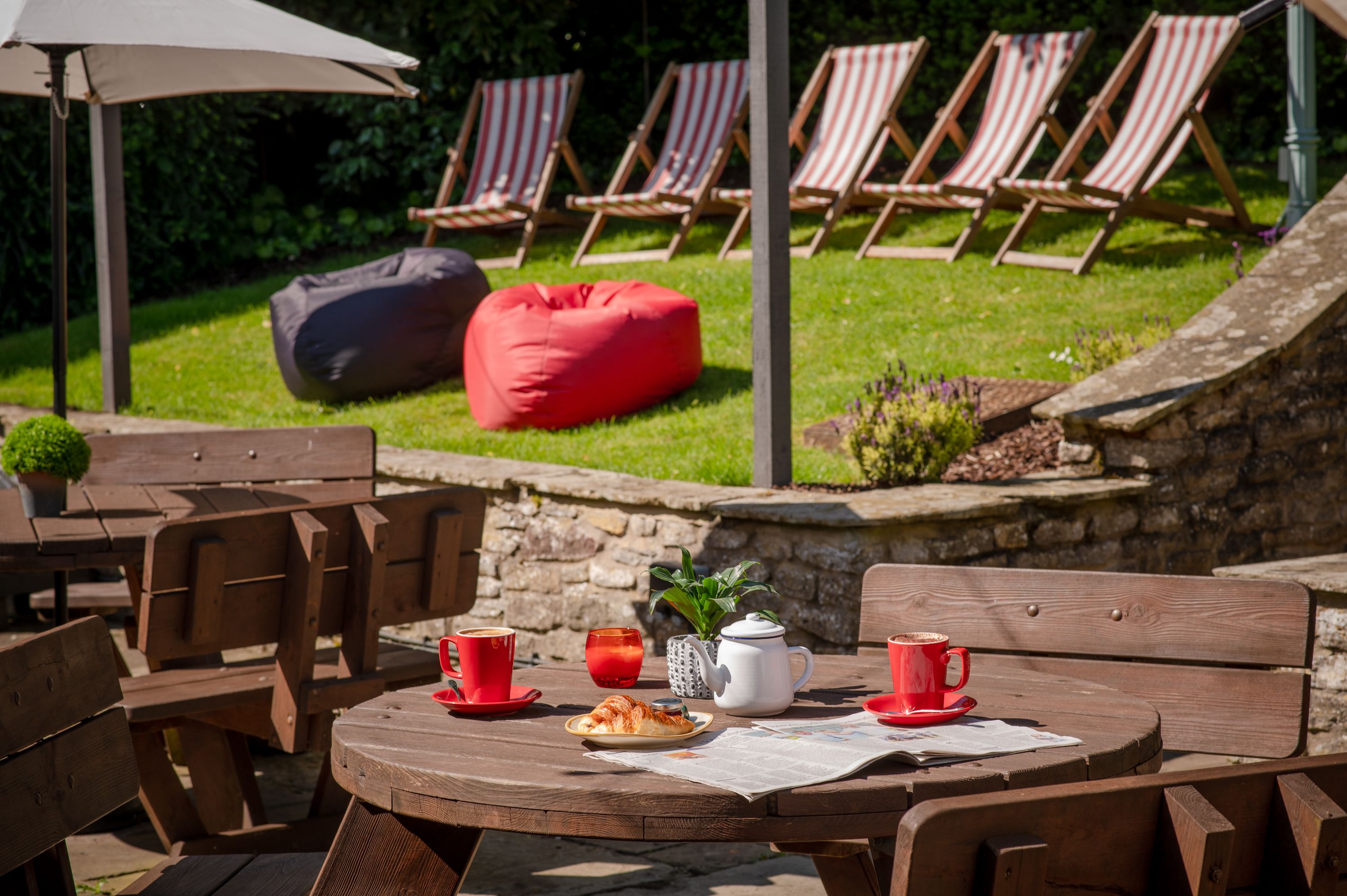Outdoor seating area with croissants and hot drinks