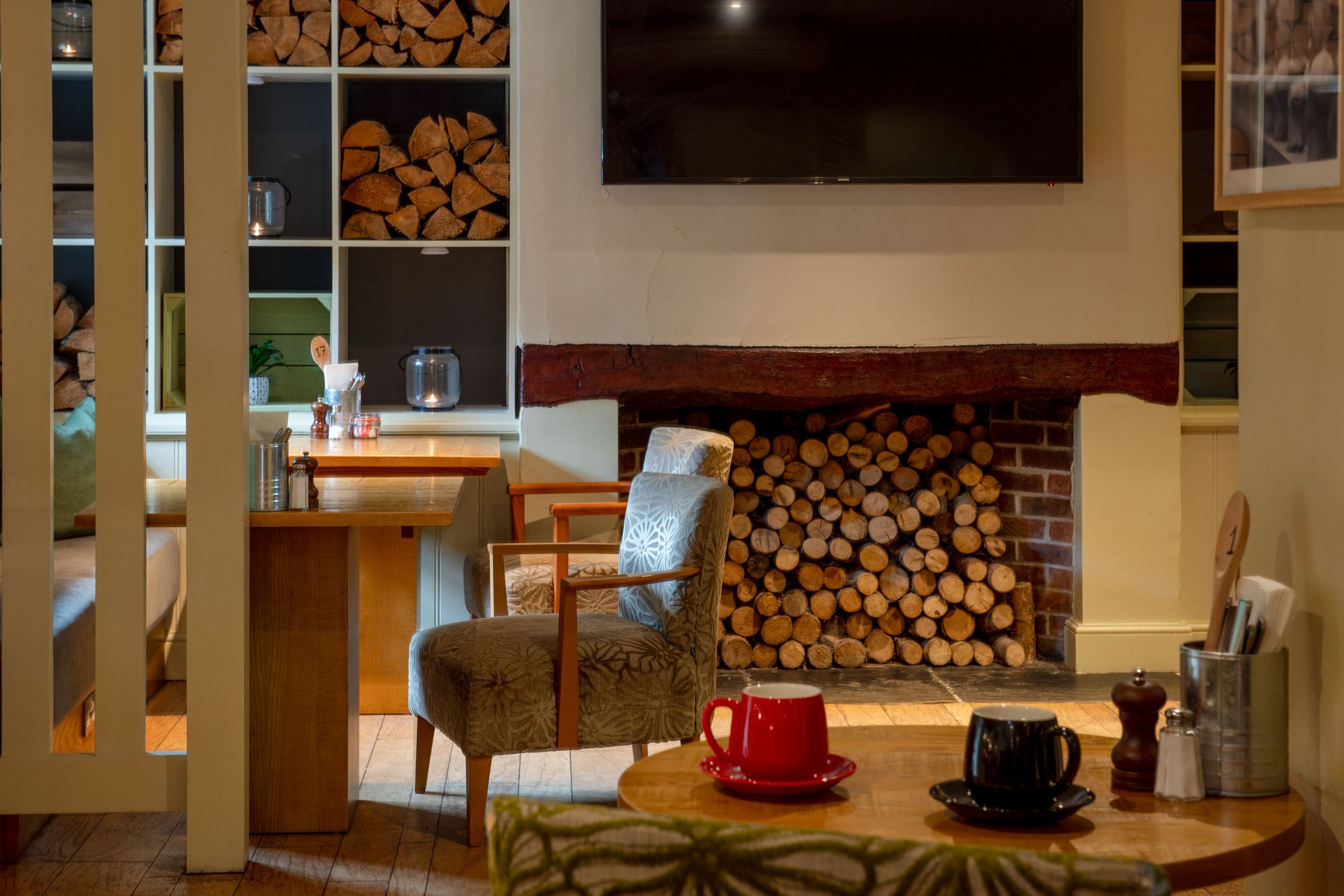 Chimney breast seating area, with cups and saucers on the table